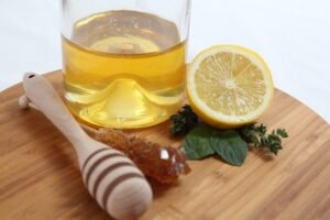 "Warm lemon, ginger, and honey drink in a glass cup, known for boosting immunity and promoting clear, glowing skin.
