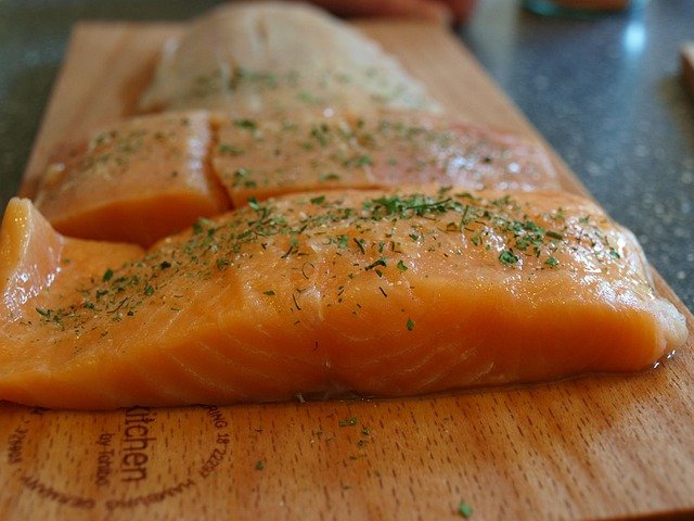 slices of salmon on wooden dish